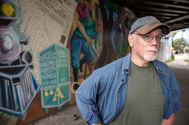 Neil Shapiro (photographed by neighbor Gordon W.) stands in front of his mural showing the evolution of the Villa neighborhood on Chicago's NW side